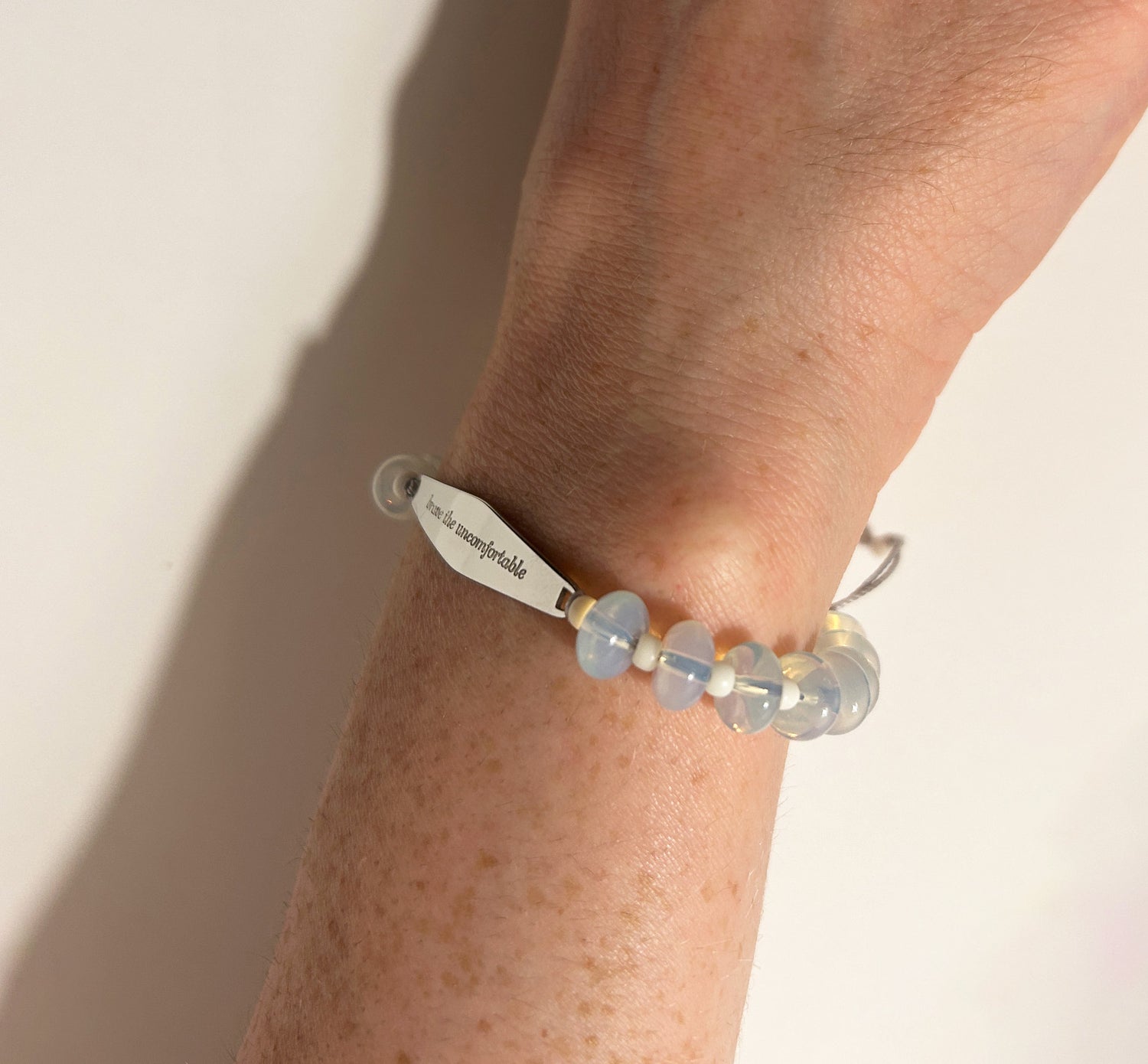 Model wearing Silver Opal Gemstone Bracelet Engraved with
