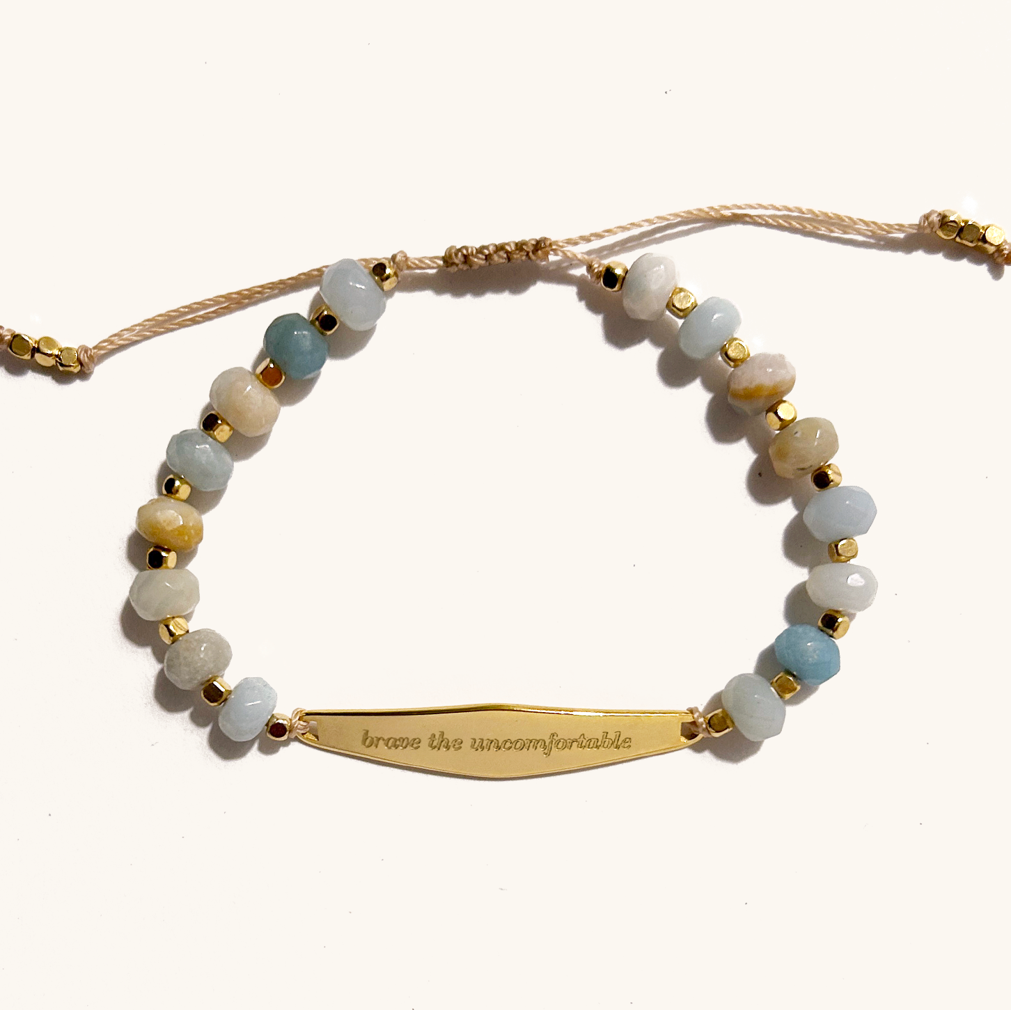 Close-up of an amazonite agate beaded bracelet, designed to help confront and manage anxiety. The bracelet features smooth, multi-colored agate beads that are known for their calming and grounding properties, symbolizing strength and courage in navigating uncomfortable emotions.