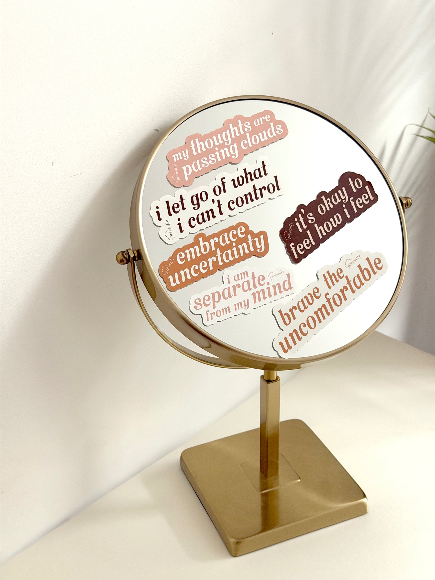 Decorative mirror with motivational phrases on a white background