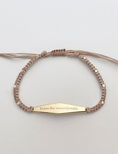 Gold Macrame Bracelet with the phrase "brave the uncomfortable"