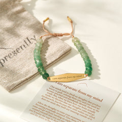 Aventurine gemstone bracelet with packaging and a card displaying the engraved phrase "I am separate from my mind," part of Presently's mindfulness collection for OCD and anxiety.