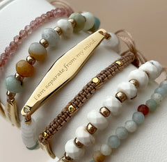 Close-up of Presently's beaded bracelets engraved with "I am separate from my mind," highlighting the delicate engraving and soothing gemstone beads designed for mindfulness and mental wellness.