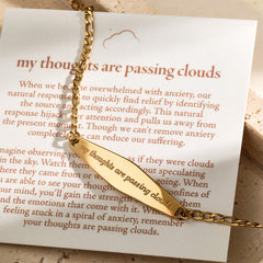 A detailed close-up of the silver Figaro Chain Bracelet engraved with "My thoughts are passing clouds," highlighting its delicate engraving and polished finish.