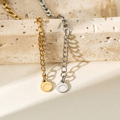 A macro shot of the Presently Bracelets logo tag, highlighting the engraved branding on the bracelet.