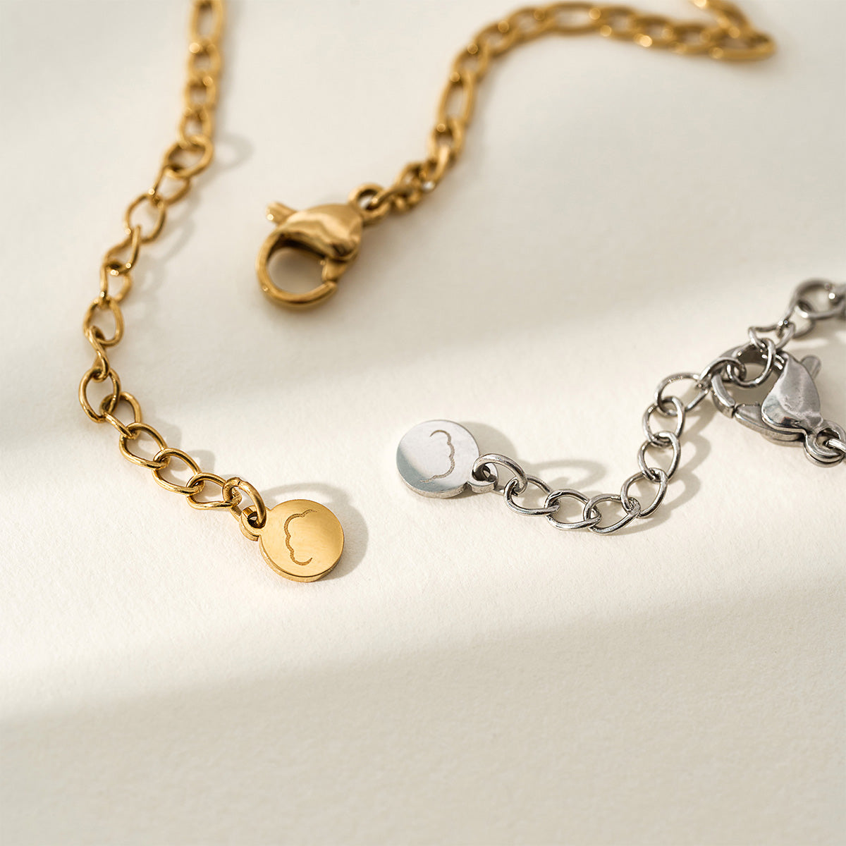 A close-up shot of the Presently Bracelets logo tag and lobster clasp, emphasizing the fine craftsmanship and branding details.
