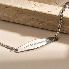 A silver Figaro Chain Bracelet featuring the engraved phrase "I am separate from my mind," displayed against a neutral background.