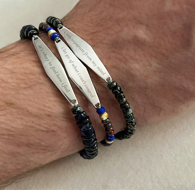 Model wearing Presently's Men's Beaded Bracelet Collection, featuring a variety of natural stone beads and engraved reminders designed to support anxiety and OCD.