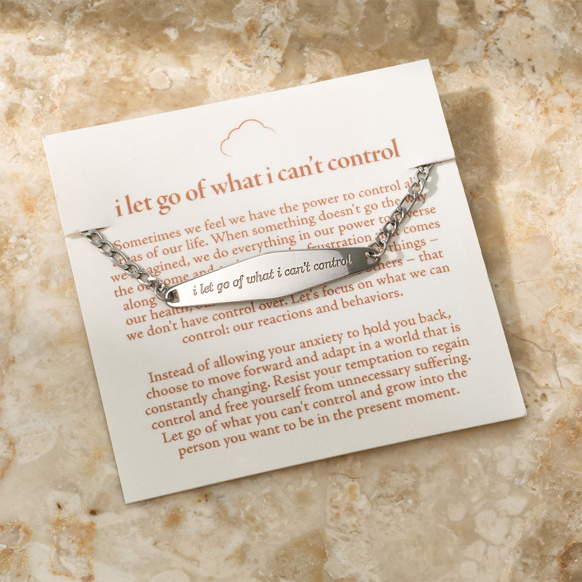 A silver Figaro Chain Bracelet featuring the engraved phrase 