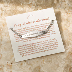 A silver Figaro Chain Bracelet featuring the engraved phrase "I am separate from my mind," displayed against a neutral background.