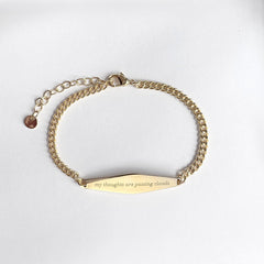 Gold Curb Chain Bracelet Engraved with the phrase "my thoughts are passing clouds"