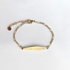 Gold Figaro Mindfulness Bracelet Engraved with the phrase "my thoughts are passing clouds"