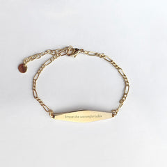 Gold Figaro Mindfulness Bracelet Engraved with the phrase "brave the uncomfortable"