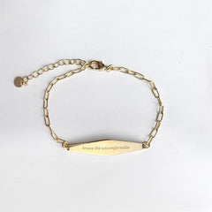 Gold Paper Clip Mindfulness Bracelet Engraved with the phrase "brave the uncomfortable"