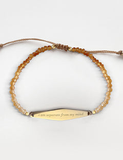 Gold Hessonite Gemstone Bracelet with the phrase "i am separate from my mind"