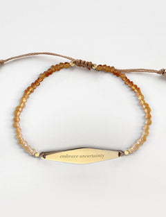 Gold Hessonite Gemstone Bracelet with the phrase "embrace uncertainty"