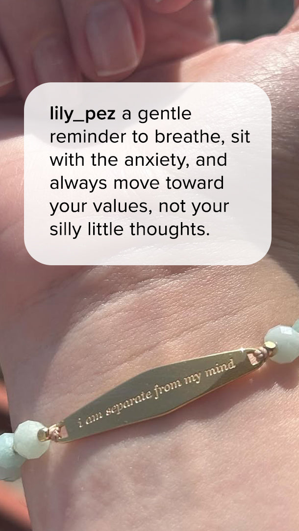 Gold “I Am Separate From My Mind” gemstone reminder bracelet worn on a wrist. Customer quote reads, “A gentle reminder to breathe, sit with the anxiety, and always move toward your values, not your silly little thoughts.”