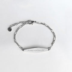 Silver Figaro Mindfulness Bracelet Engraved with the phrase "it's okay to feel how i feel"