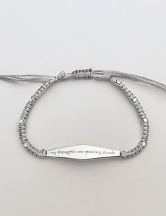 Silver Macrame Bracelet with the phrase "my thoughts are passing clouds"