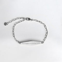 Silver Paper Clip Mindfulness Bracelet Engraved with the phrase "my thoughts are passing clouds"