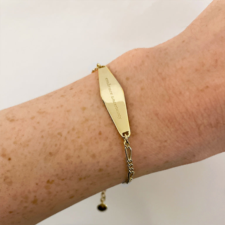 Gold Figaro Chain Bracelet engraved with the phrase 