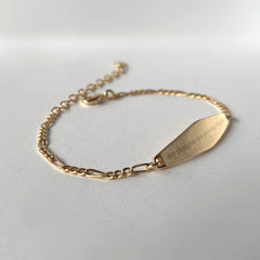 Gold Figaro Chain Bracelet engraved with the phrase "my thoughts are passing clouds"